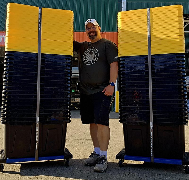 Tori standing between two full columns of moving totes on Tote Carts