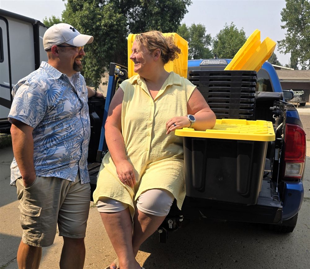 Traci and Tori of TNT Rental laughing together at the tailgate of their loaded truck